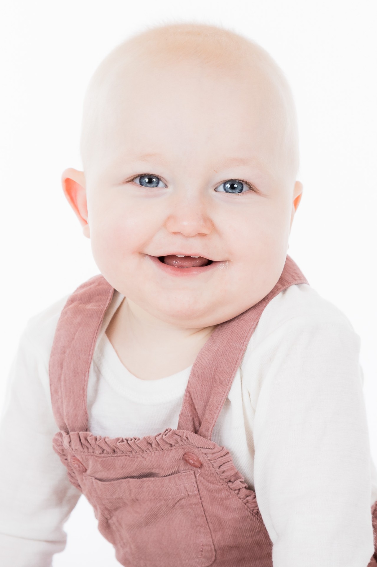 Smilende baby under fotografering